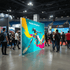 seg lightbox backdrop portable display with branding at a convention center with people walking around.