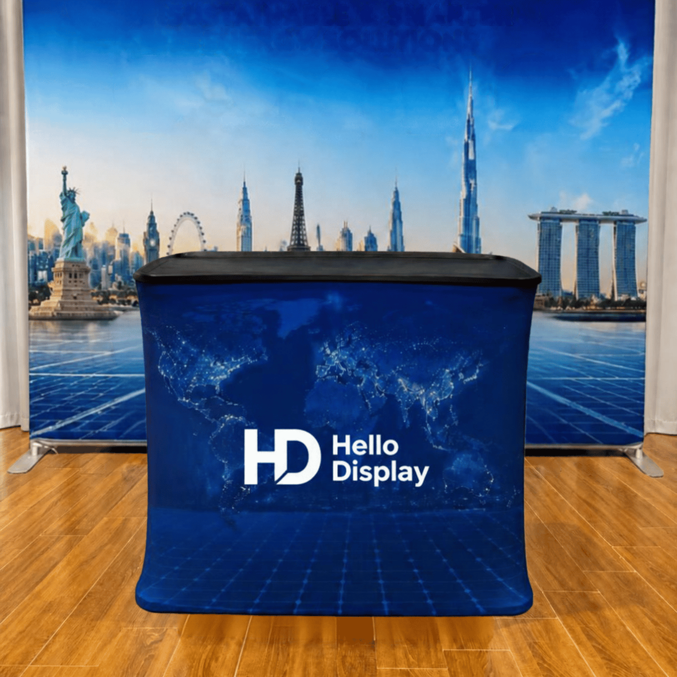 Podium counter with tension fabric graphic set up in front of a fabric exhibition backdrop